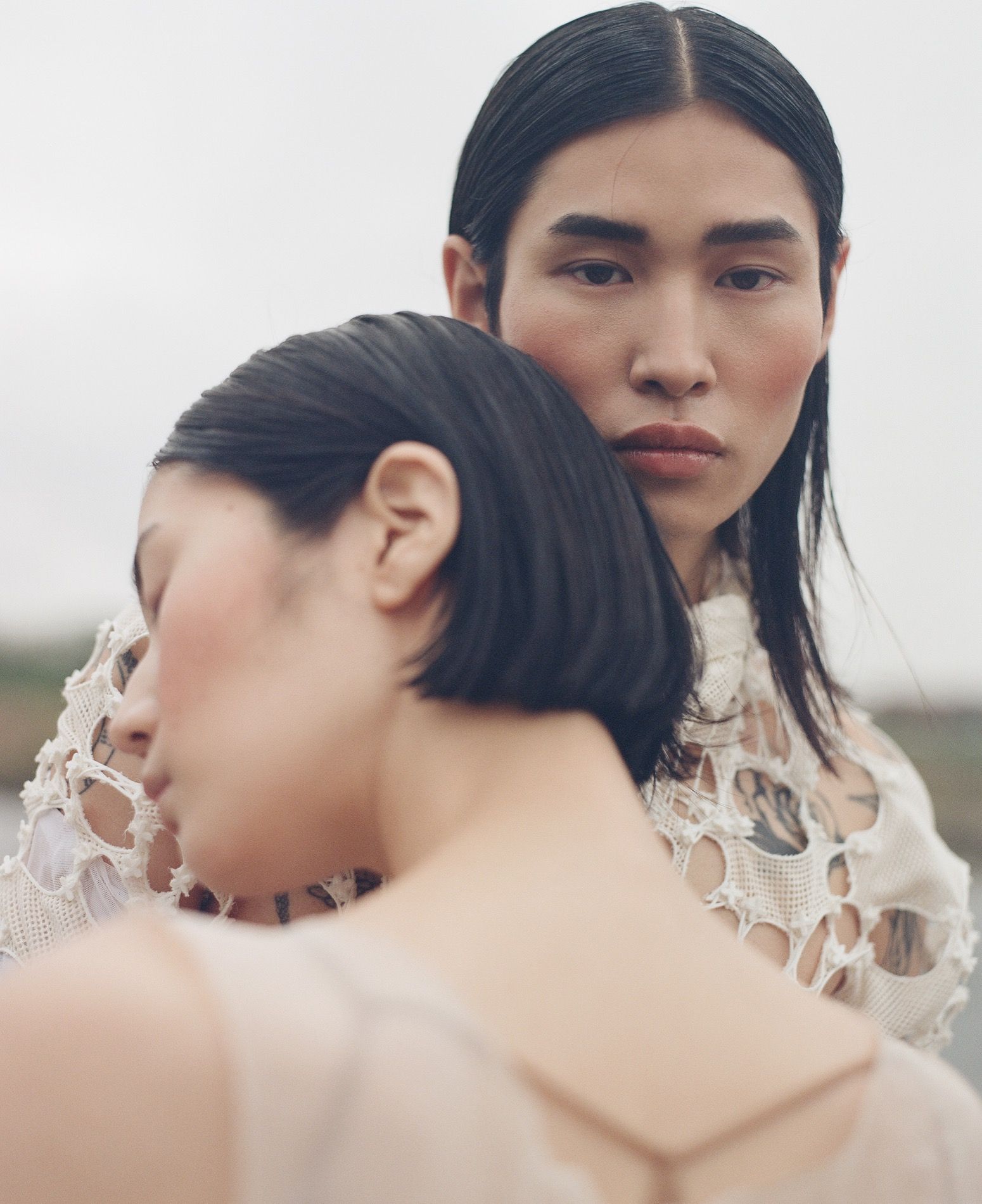 Beauty editorial, two models cheek-to-cheek with dewy make-up and wet-look hair