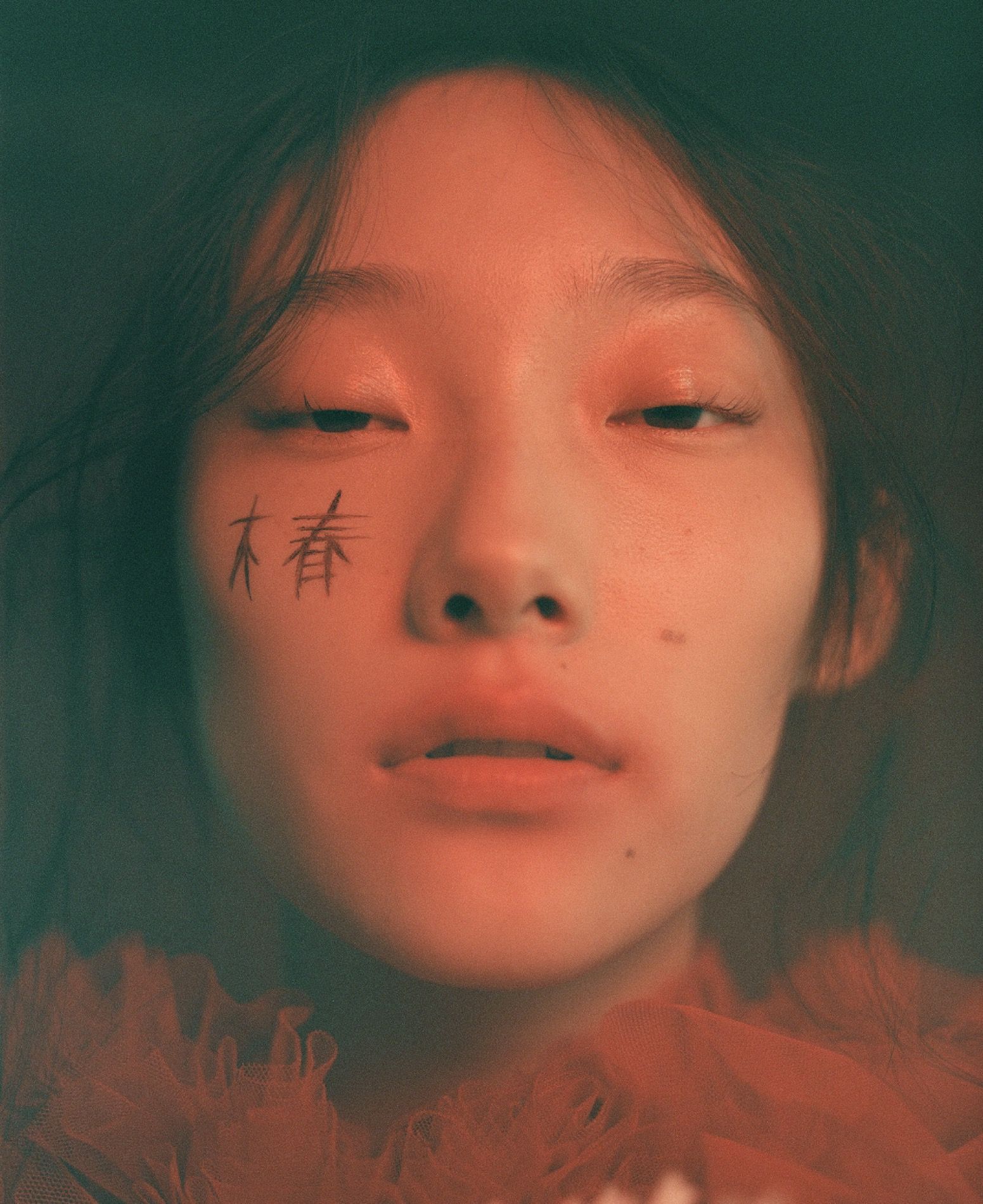 Editorial hair and make-up, dreamy portrait with drawn accents on the cheek