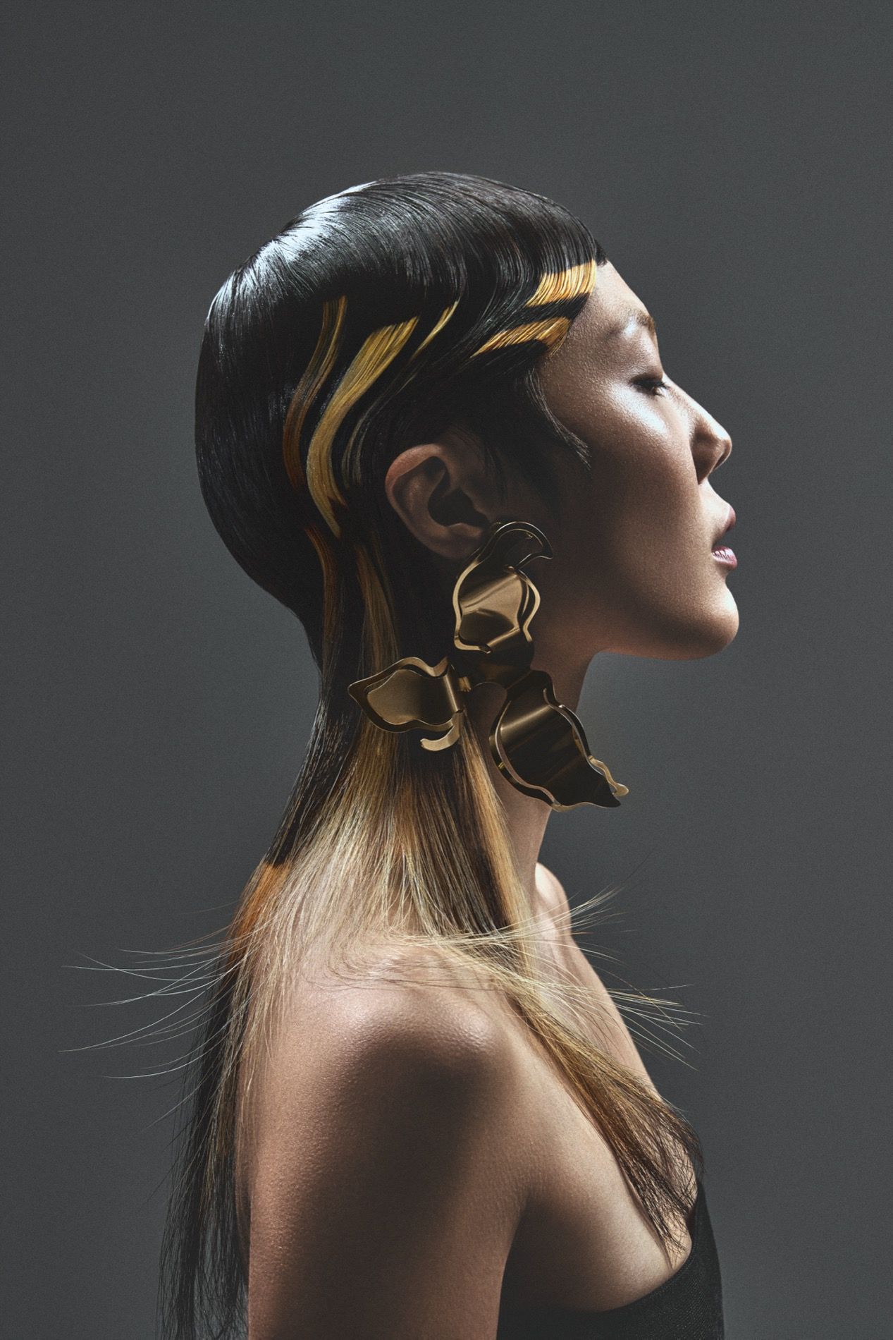 Hair editorial, sleek hair with gold in profile and gold ear piece
